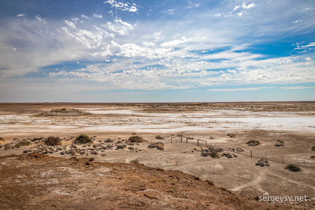 The surrounding scenery is a swirl of white, ochre, and beige.