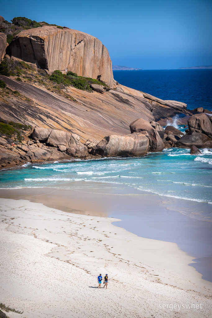 The coastal rocks and the carefree beachcombers.